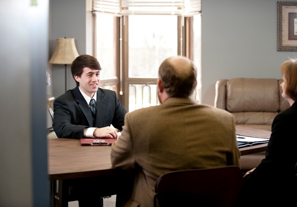 Man in suit interviewing for a job and holding a Mississippi State clipboard