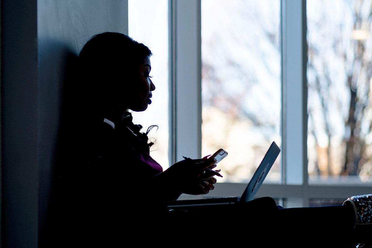 Women sitting in the window on her computer