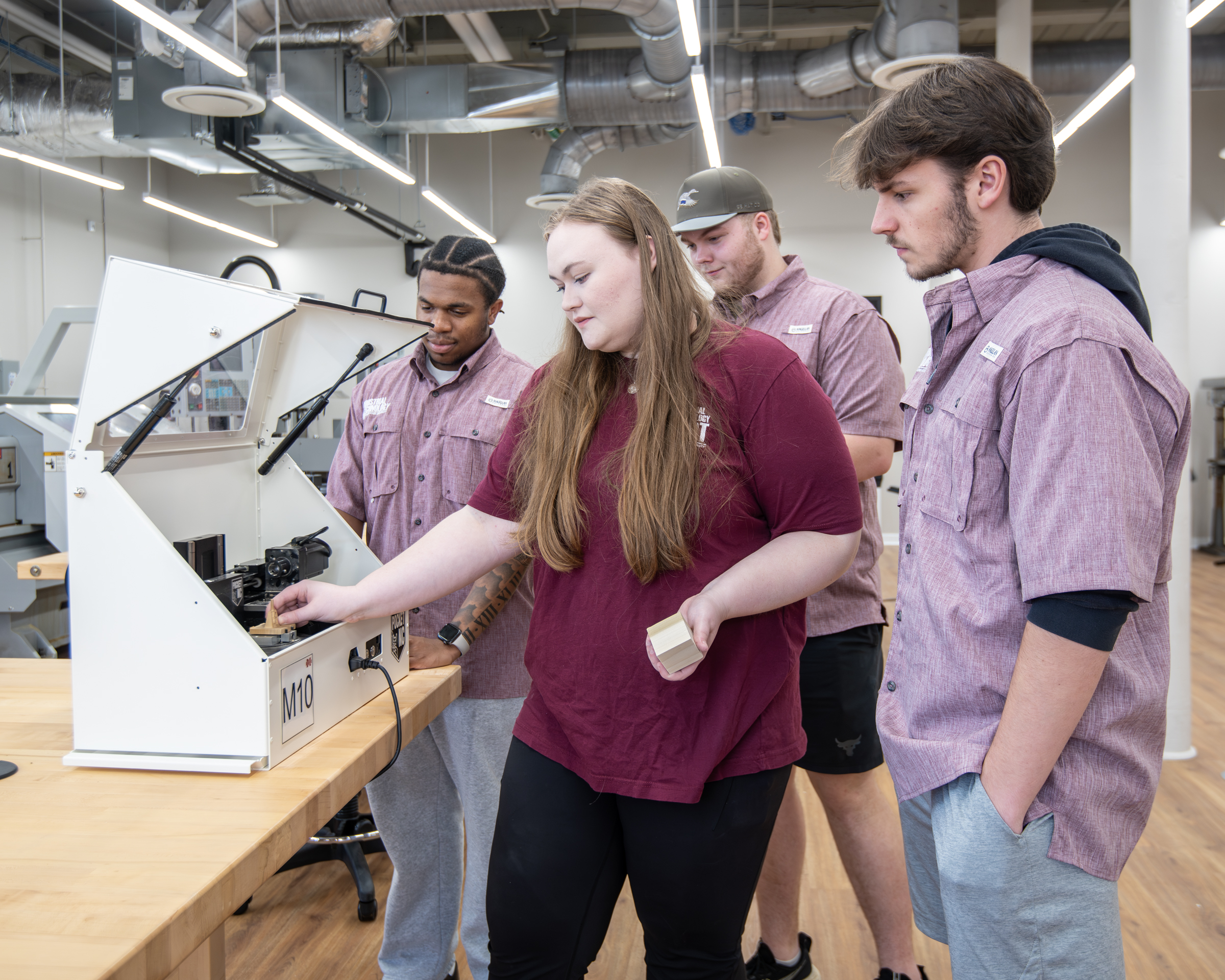 Students use advanced industrial technology during their studies.
