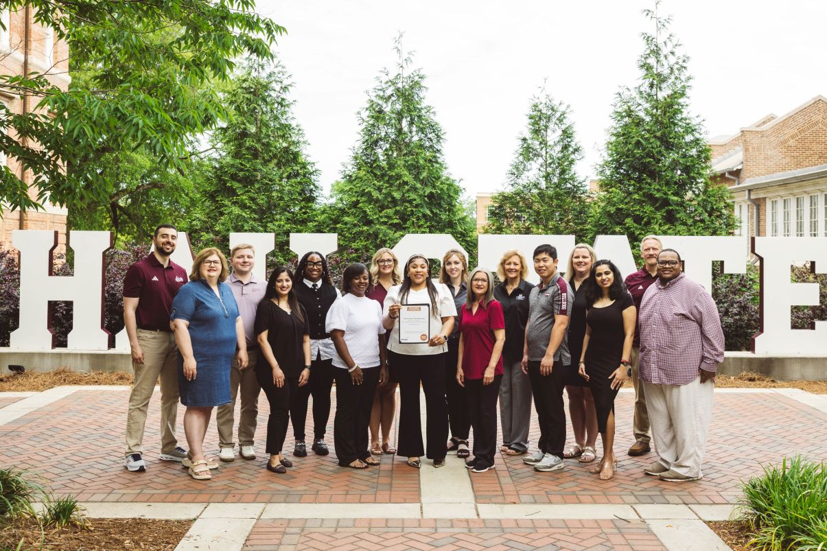Staff of MS State Online in group photo with award